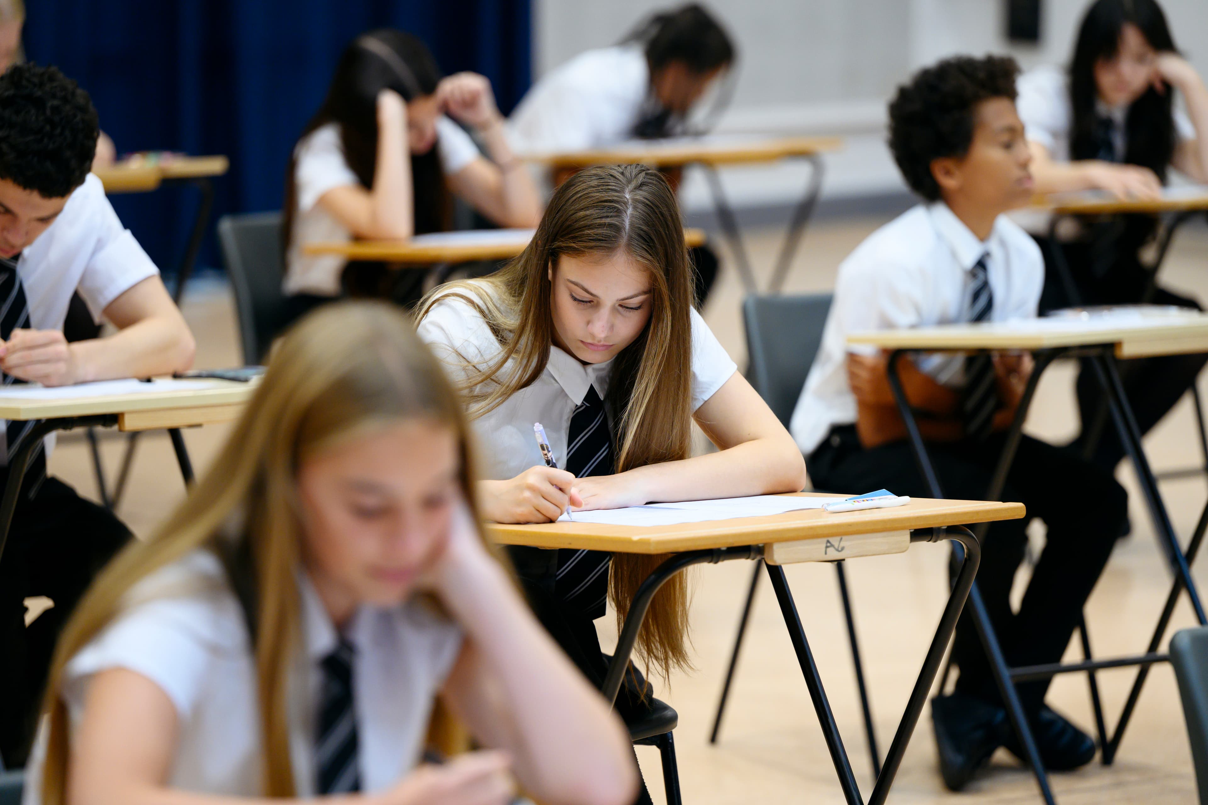 Students focused on their exams in a hall